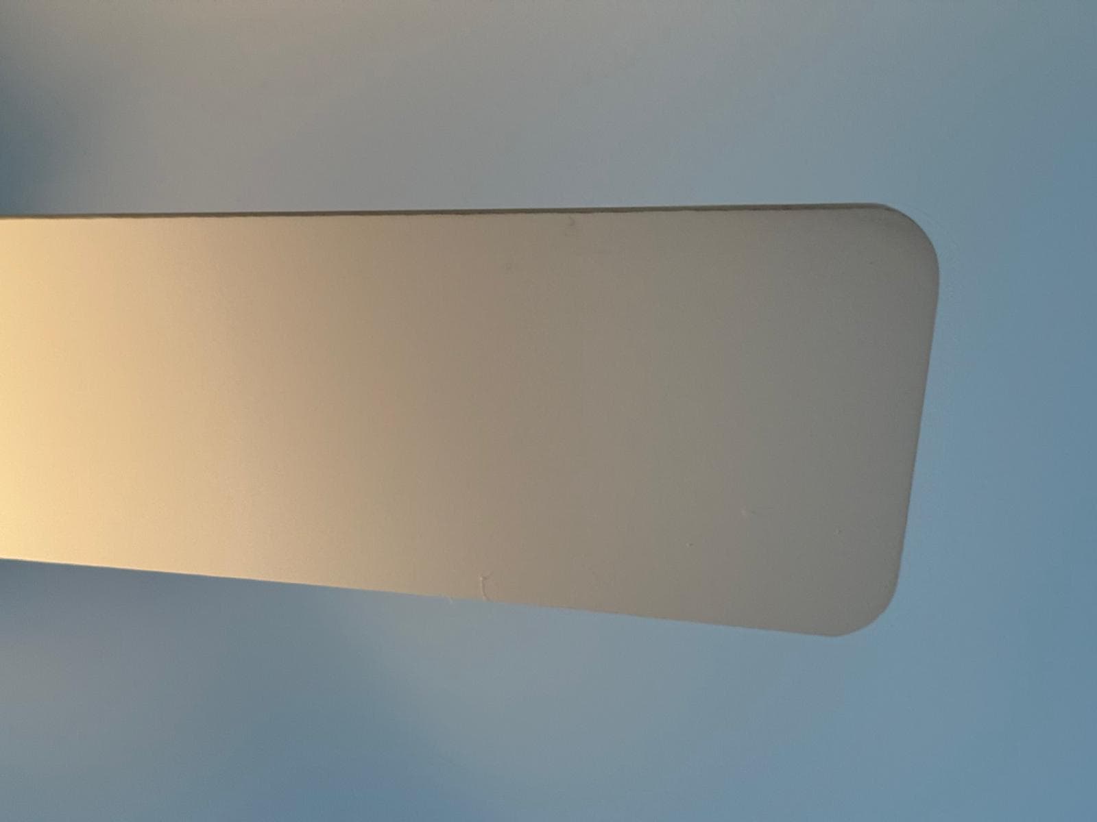 Clean white ceiling fan blade after detailing